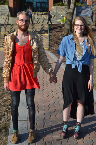 Junior sustainable development major Chris Criqui (left) and junior advertising major Shady Kimzey (right) hold hands on Sanford Mall. Throughout the month of April, some students have chosen to wear either one shirt or one dress to increase sex-trafficking awareness. Mark Kenna | The Appalachian